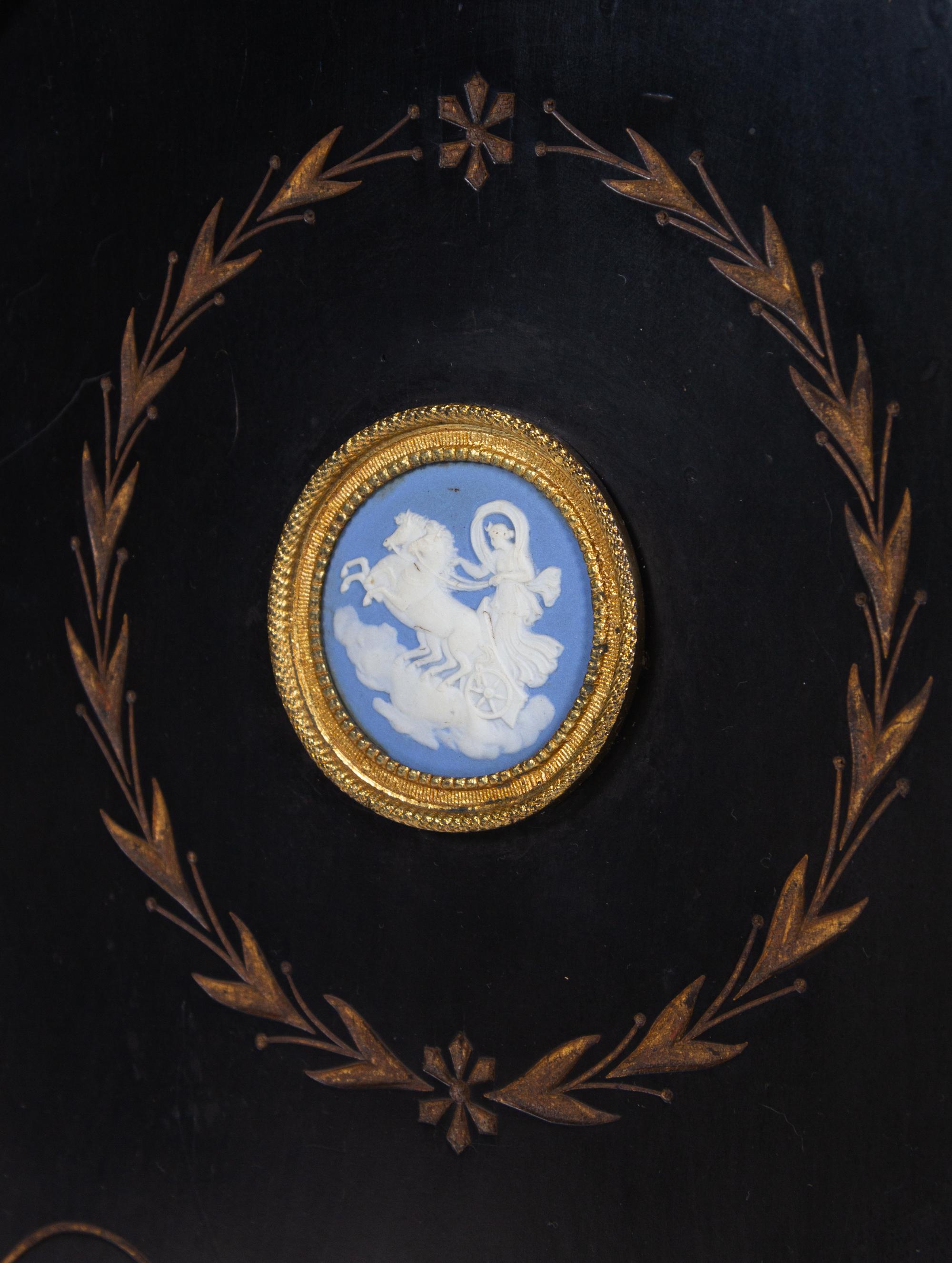 A Pair of English Aesthetic Jasperware Medallion-Mounted Ebonized and Parcel-Gilt Pedestal Cabinets