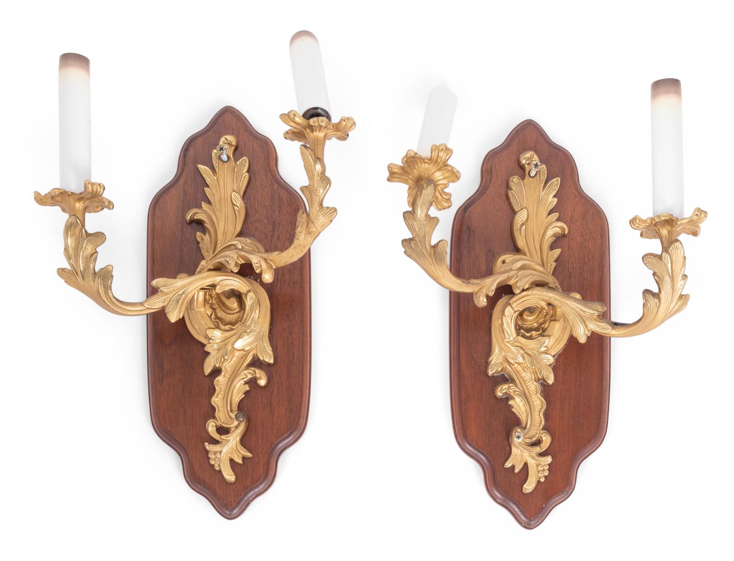 A Pair of Louis XV Style Gilt Metal Two-Light Sconces on Walnut Plaques