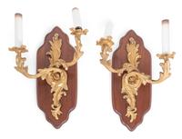 A Pair of Louis XV Style Gilt Metal Two-Light Sconces on Walnut Plaques