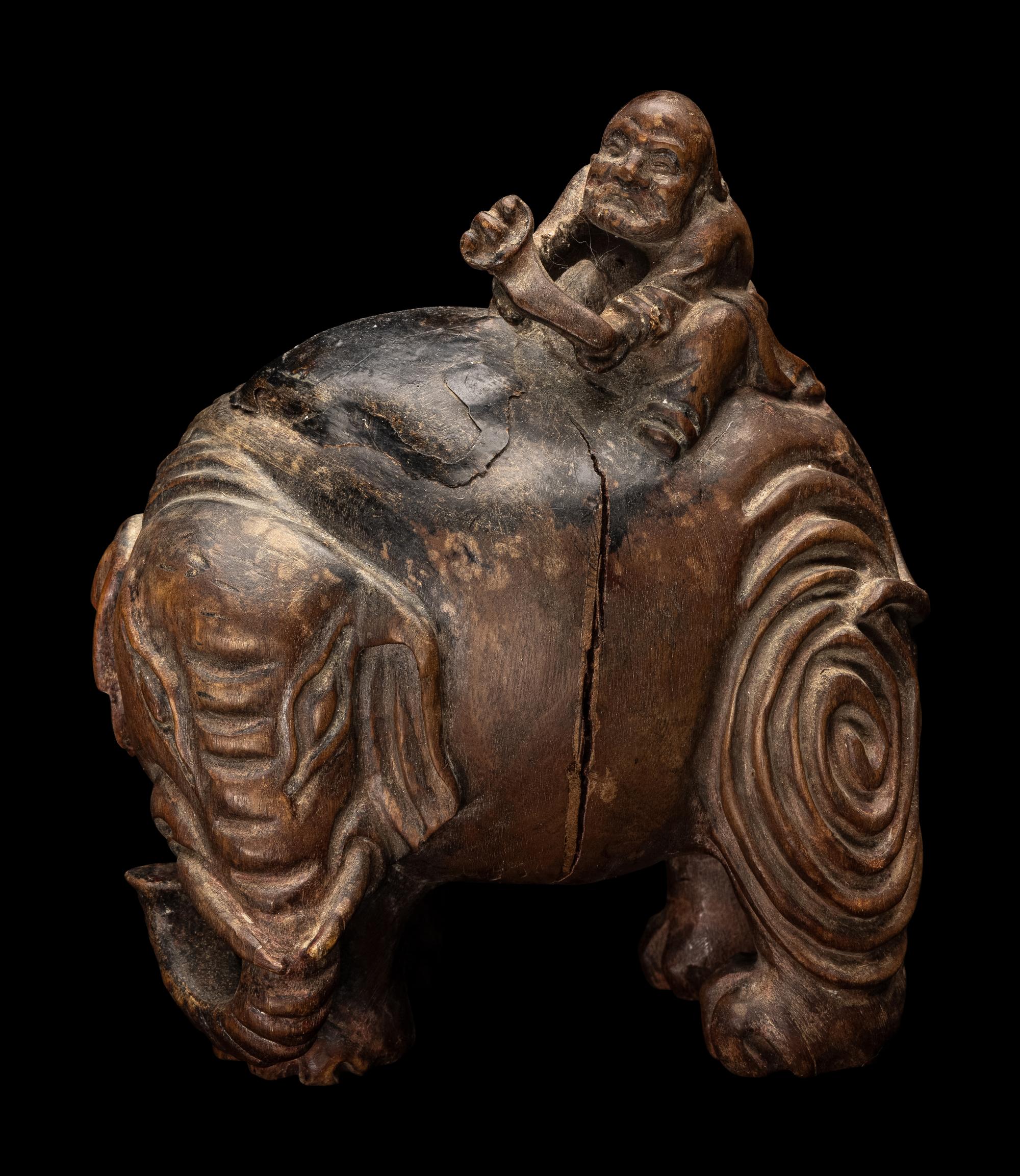 A Chinese Carved Wood 'Foreigner and Elephant' Figural Group