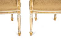 A Set of Eight Louis XVI Style Painted and Parcel Gilt Fauteuils