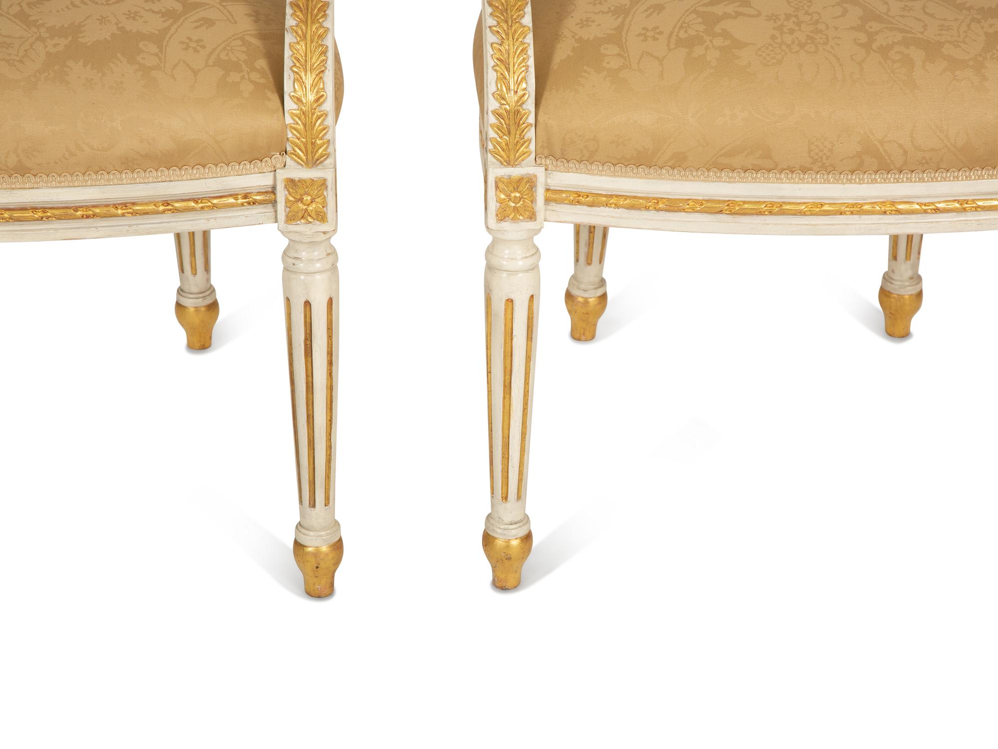 A Set of Eight Louis XVI Style Painted and Parcel Gilt Fauteuils