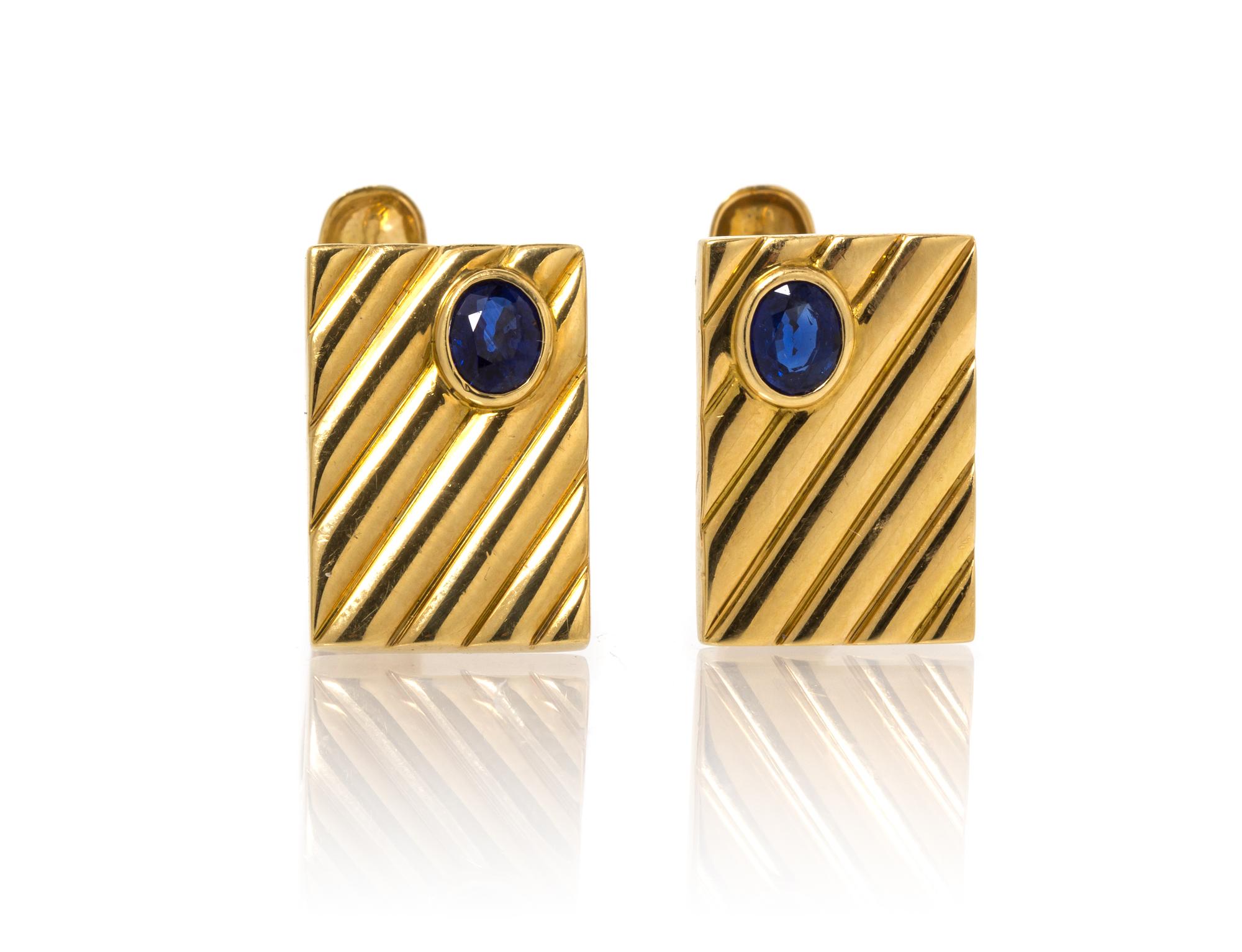 A Pair of 18 Karat Yellow Gold and Sapphire Cufflinks. 8.90 dwts.