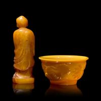 A Chinese Carved Stone "Luohan" Seal and a Yellow "Peking" Glass Bowl 壽山石雕羅漢和黃料花卉紋盌各一