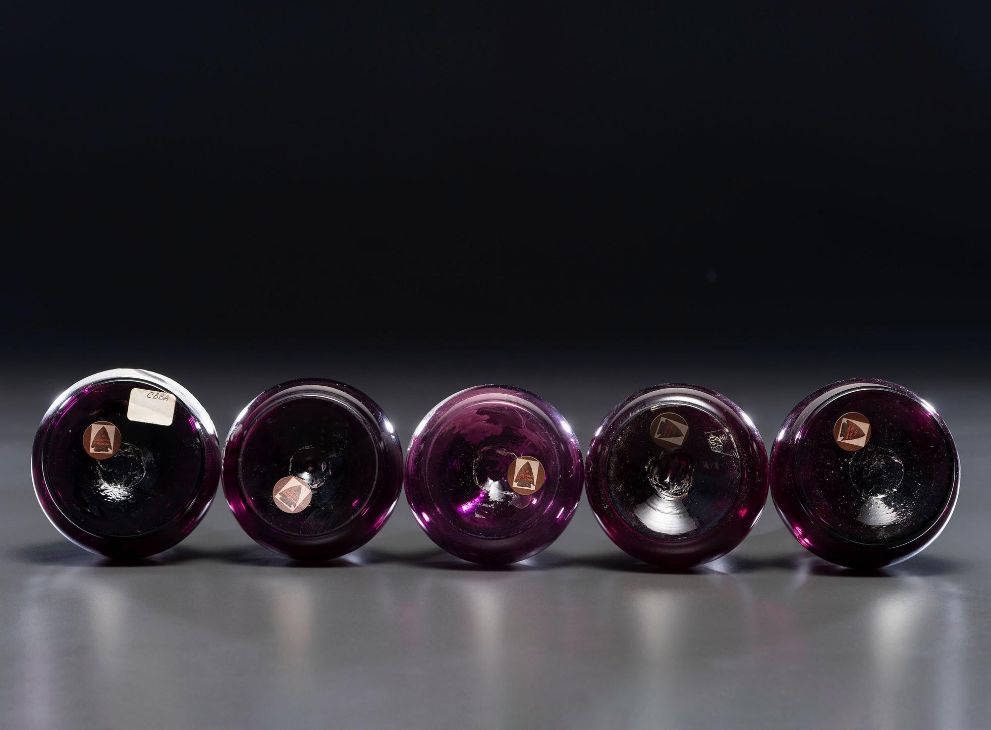Five 'Mary Gregory' Amethyst Glass Barber Bottles