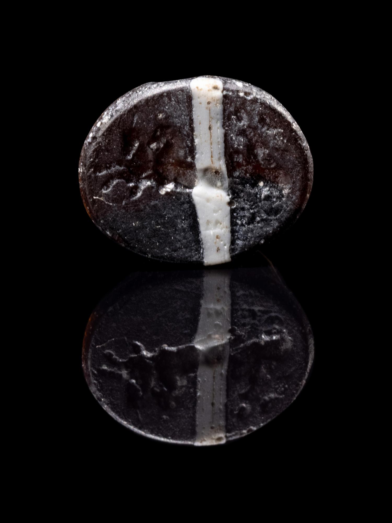 A Roman Steatite Ring Stone with Victory Riding a Chariot