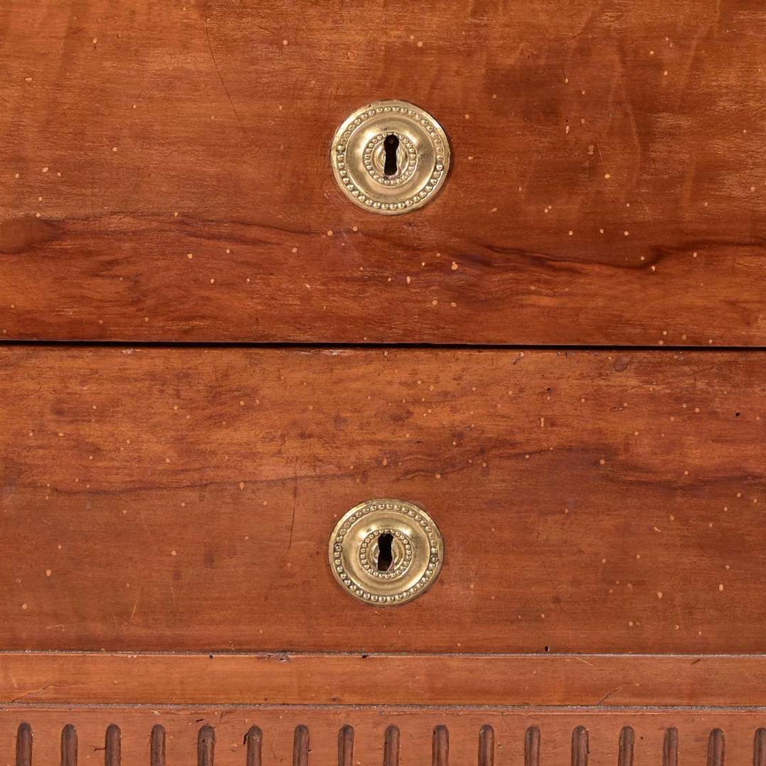 A French Directoire carved fruitwood commode with white marble top circa 1800