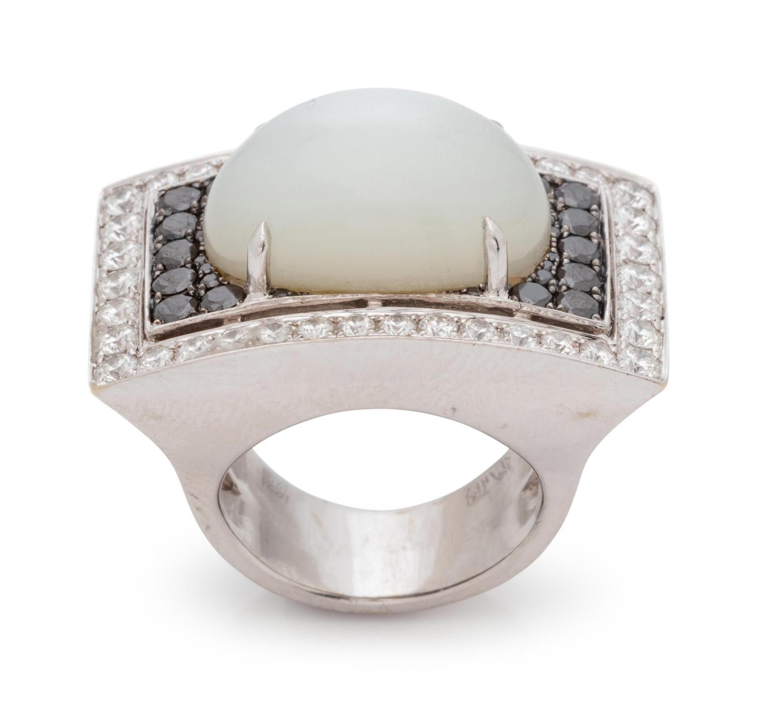 An 18 Karat White Gold, Moonstone, Black Diamond, and Diamond Ring,