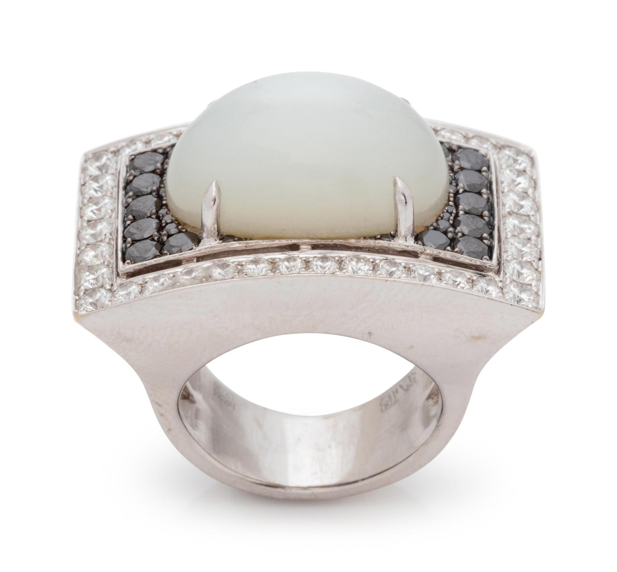 An 18 Karat White Gold, Moonstone, Black Diamond, and Diamond Ring,