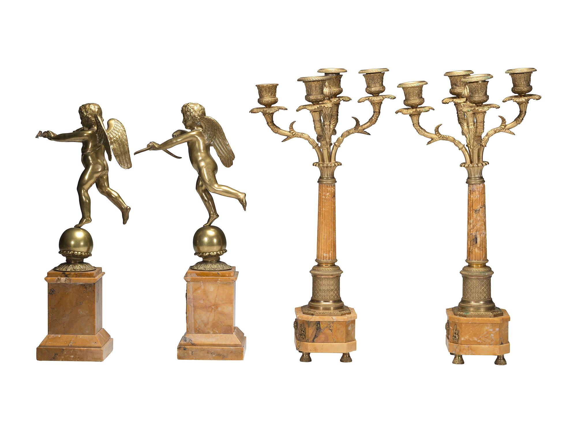 A Pair of Brass and Marble Cherub Bookends and Four-Light Candelabra