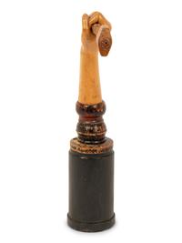 A Folk Art Carved and Polychrome Painted Hand Clutching a Hammer
