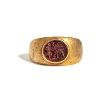 A Roman Gold and Carnelian Finger Ring with Eros Hunting