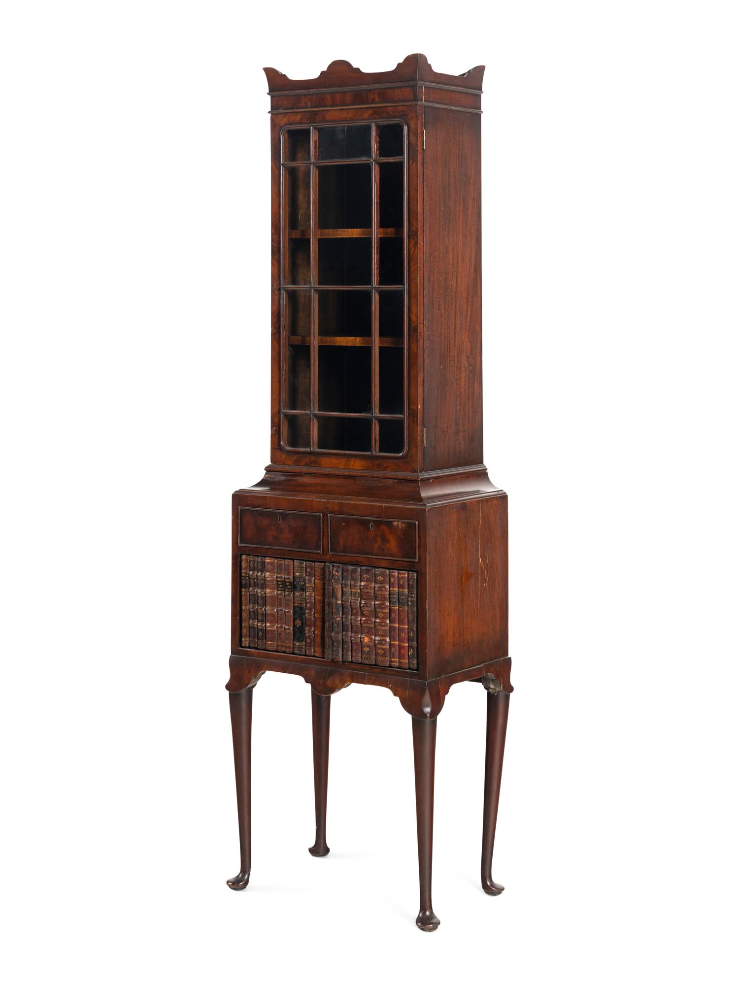 A Regency Mahogany and Faux-Book Decorated Vitrine Cabinet on Stand