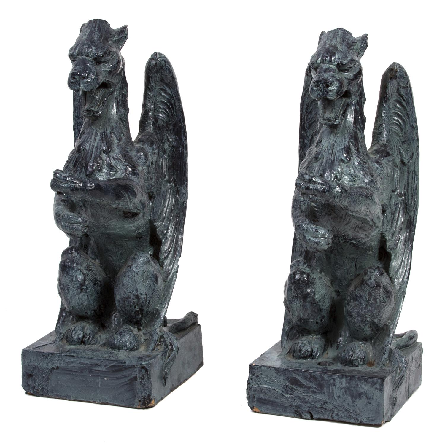 A Pair of Patinated Ceramic Winged Gryphons Height 24 1/2 inches.