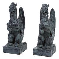 A Pair of Patinated Ceramic Winged Gryphons Height 24 1/2 inches.