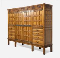 A large English Aesthetic Movement oak wardrobe Attributed to Richard Norman Shaw (1831-1912) & William Eden Nesfield (1835-1888), retailed by Maple & Co. (est. 1841), London, England, circa 1870