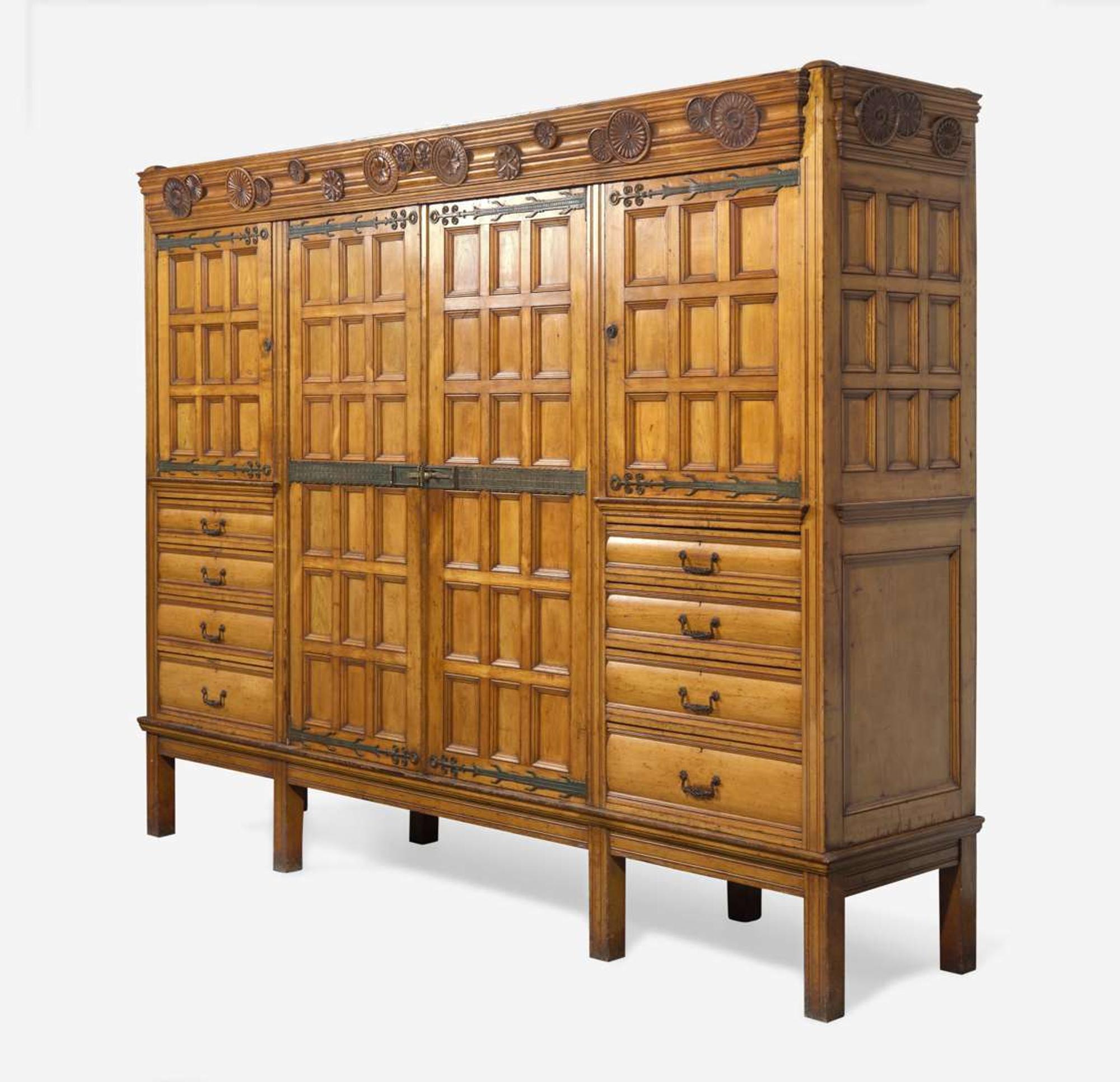 A large English Aesthetic Movement oak wardrobe Attributed to Richard Norman Shaw (1831-1912) & William Eden Nesfield (1835-1888), retailed by Maple & Co. (est. 1841), London, England, circa 1870
