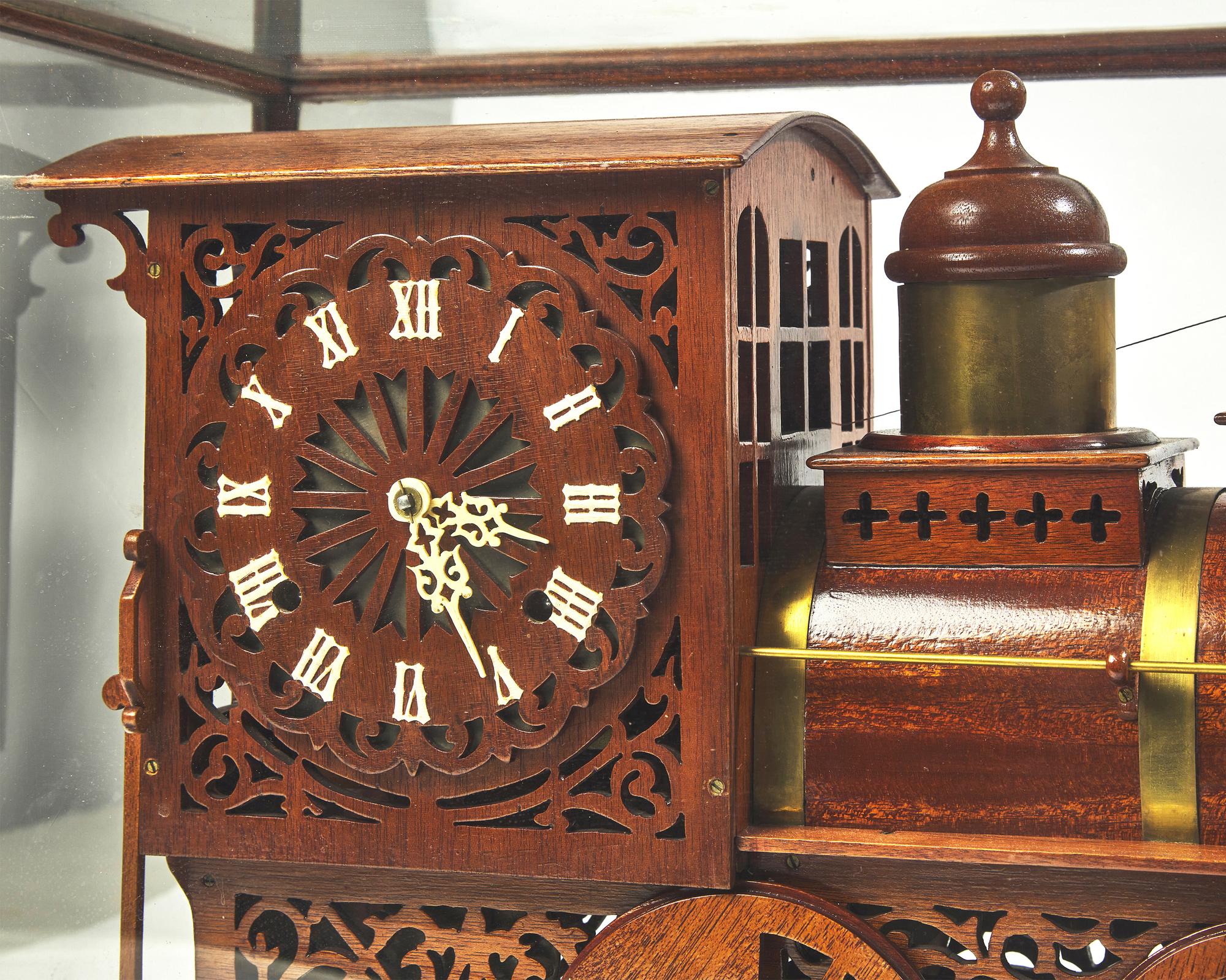 A brass-fitted mahogany 1886 steam locomotive / train fitted with clock, made by R. Davidson, April 10, 1910, works by Waterbury Clock Co.
