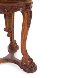 An Italian Carved Walnut Shell-Form Piano Stool