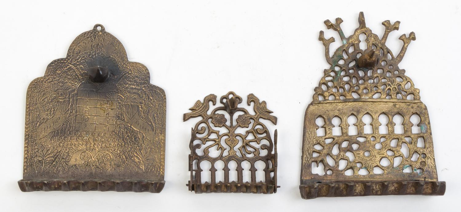 A Group of Seven Brass Menorahs Height of tallest 18 1/4 inches.