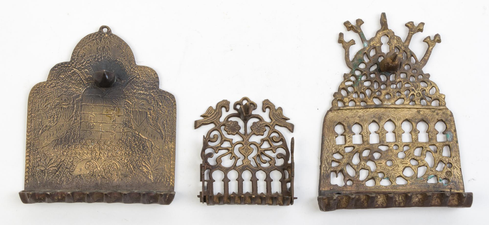 A Group of Seven Brass Menorahs Height of tallest 18 1/4 inches.