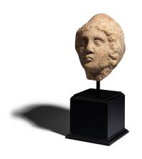 A Roman Marble Head of a Man Wearing a Phyrigian Cap