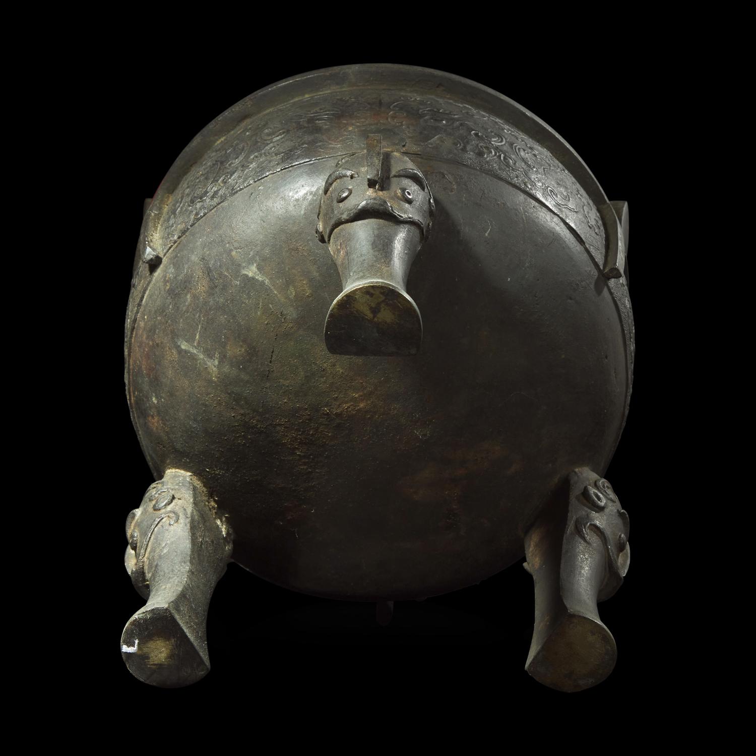 A large Chinese patinated bronze archaistic tripod censer, Ding, and wood cover, The Bronze 17th/18th Century or Earlier 清 青銅鼎式爐