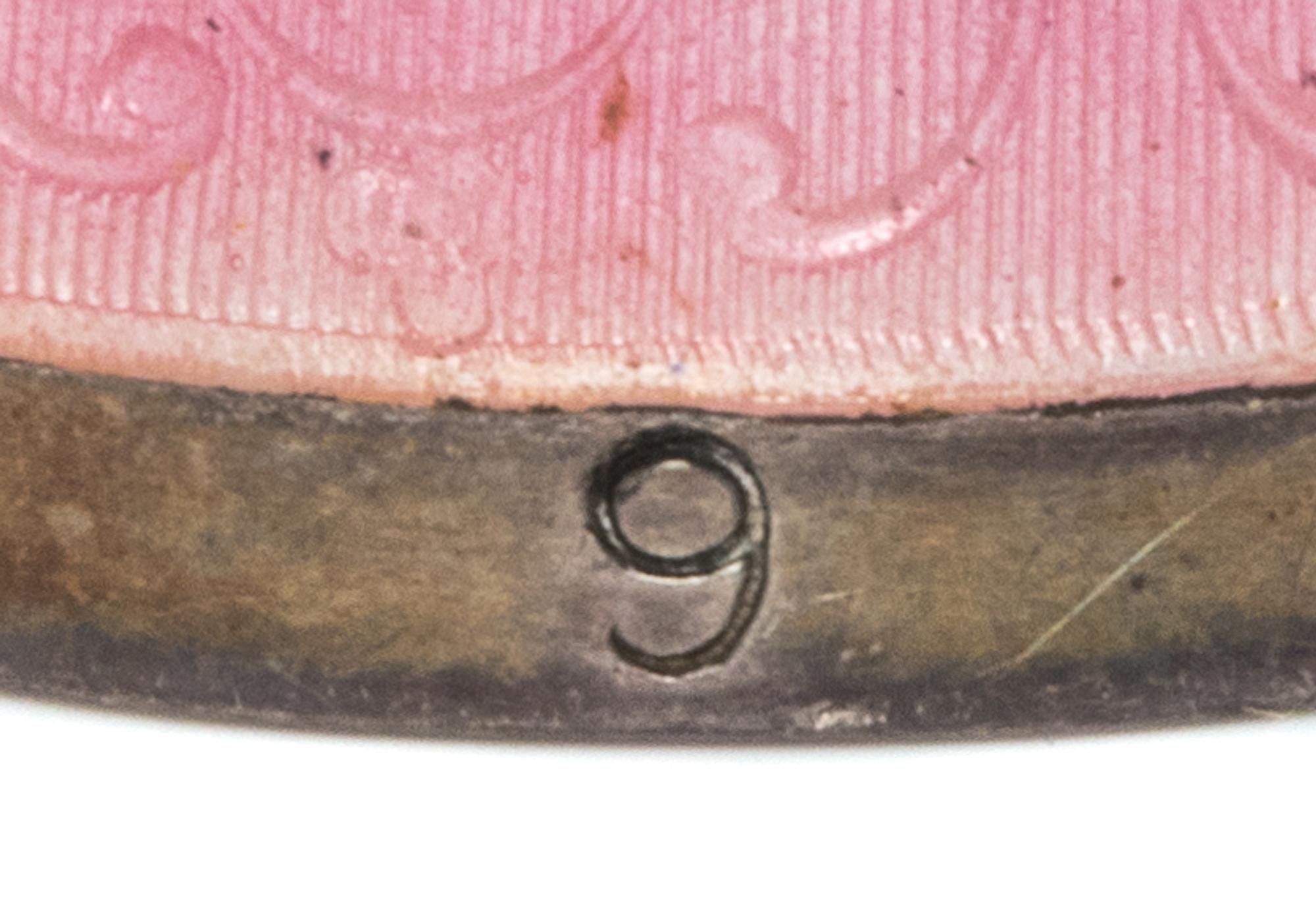 An American Silver and Guilloche Enamel Thimble, Simons Bros., Philadelphia, PA, the knurled top and body above a pink guilloche enamel
