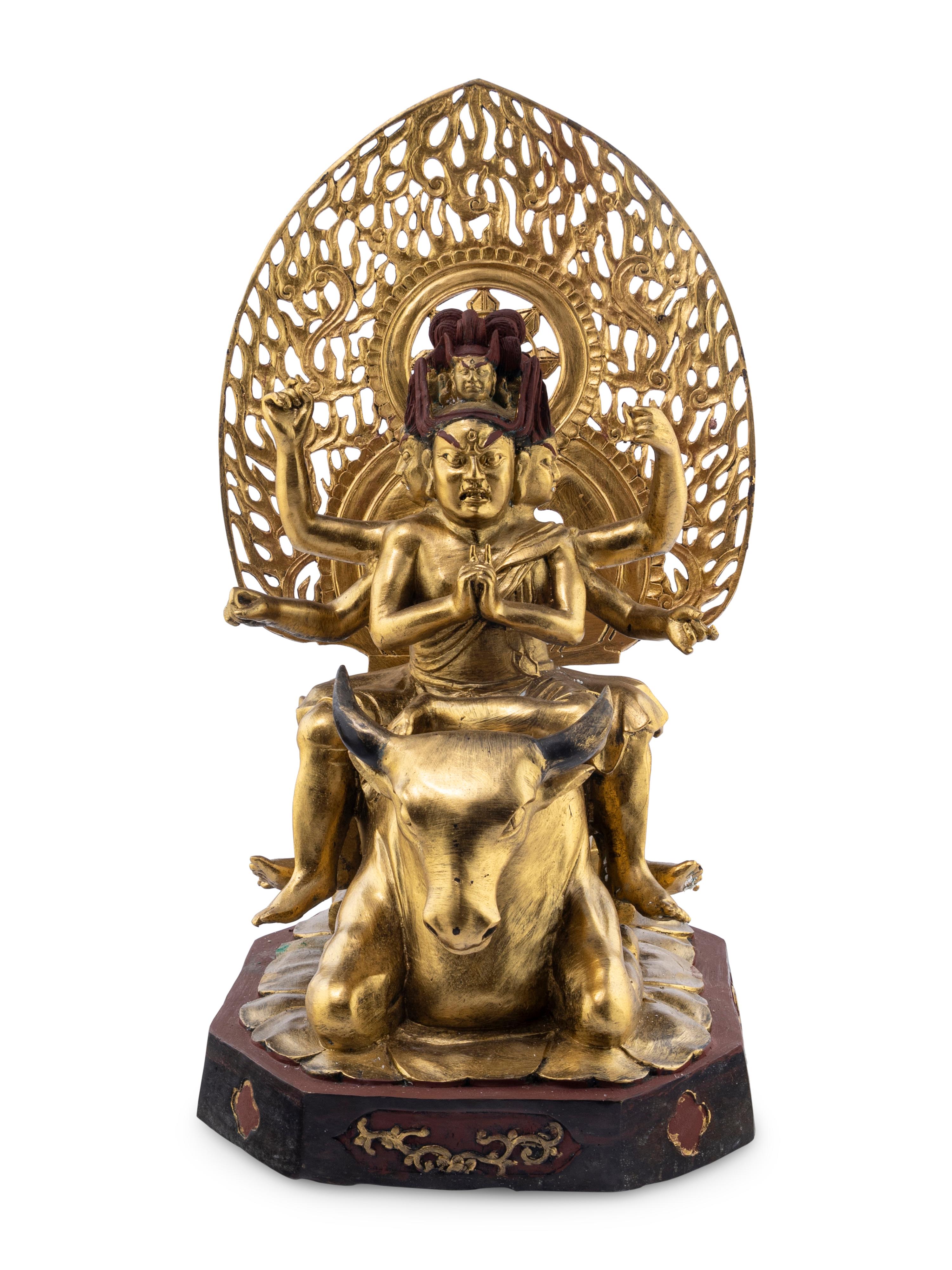 A Gilt and Red Lacquered Bronze Figure of a Multi-Armed Deity