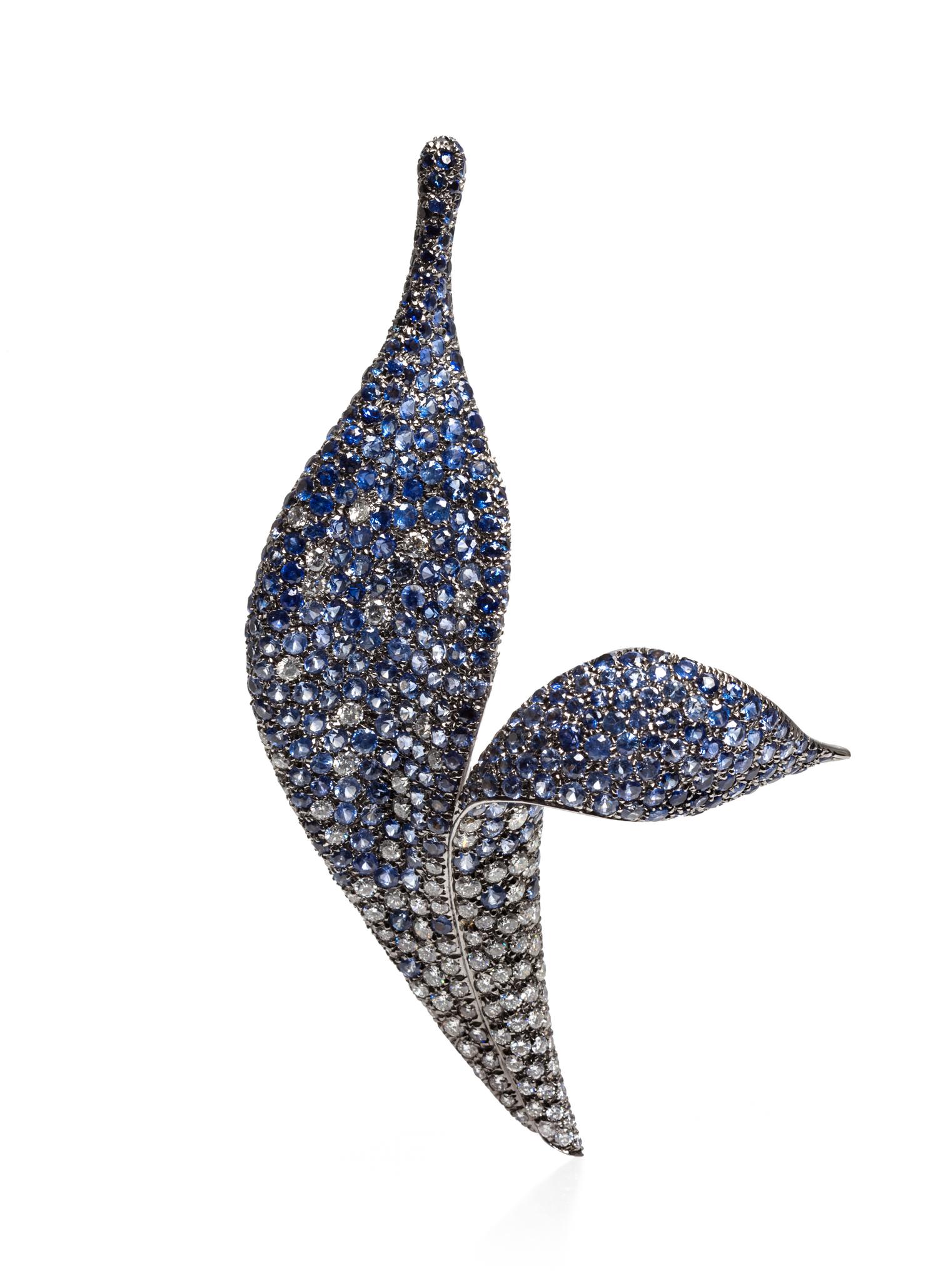 An 18 Karat White Gold, Diamond and Sapphire Brooch, 26.40 dwts.
