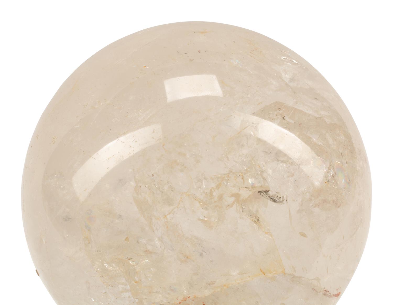 A Rock Crystal Spherical Ornament on a Patinated Bronze Figural Base