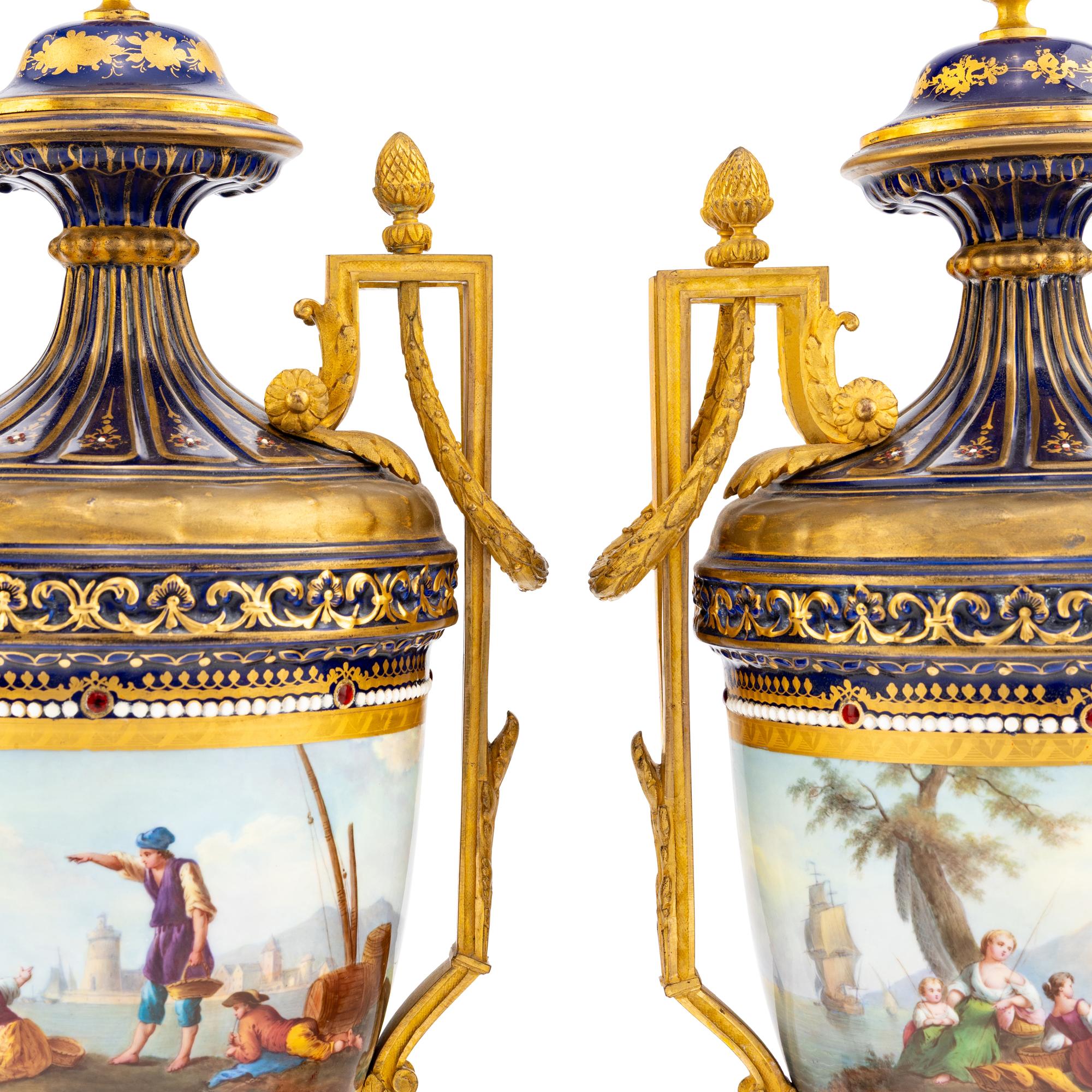 A Pair of Sèvres Style Gilt Bronze Mounted Porcelain Urns