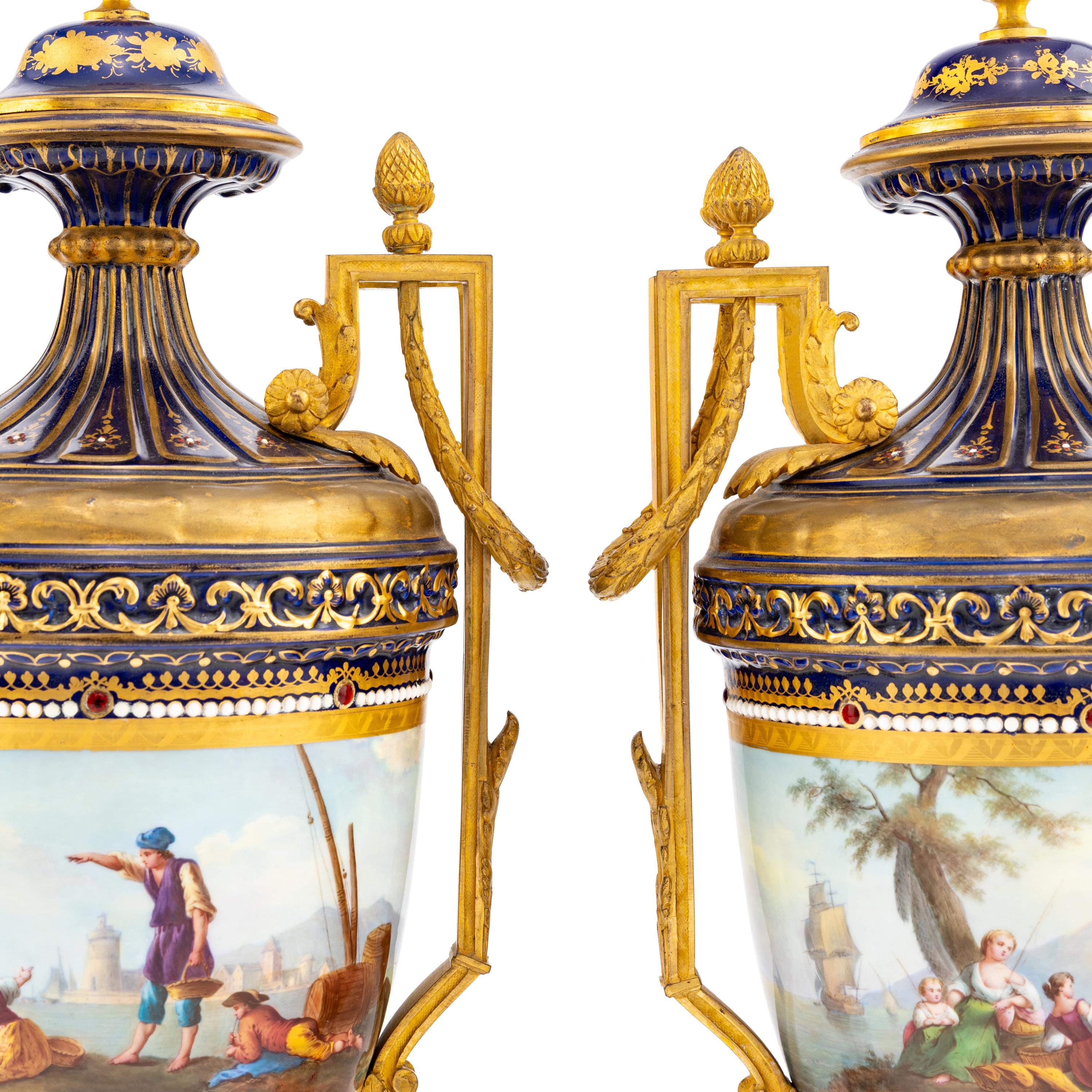A Pair of Sèvres Style Gilt Bronze Mounted Porcelain Urns