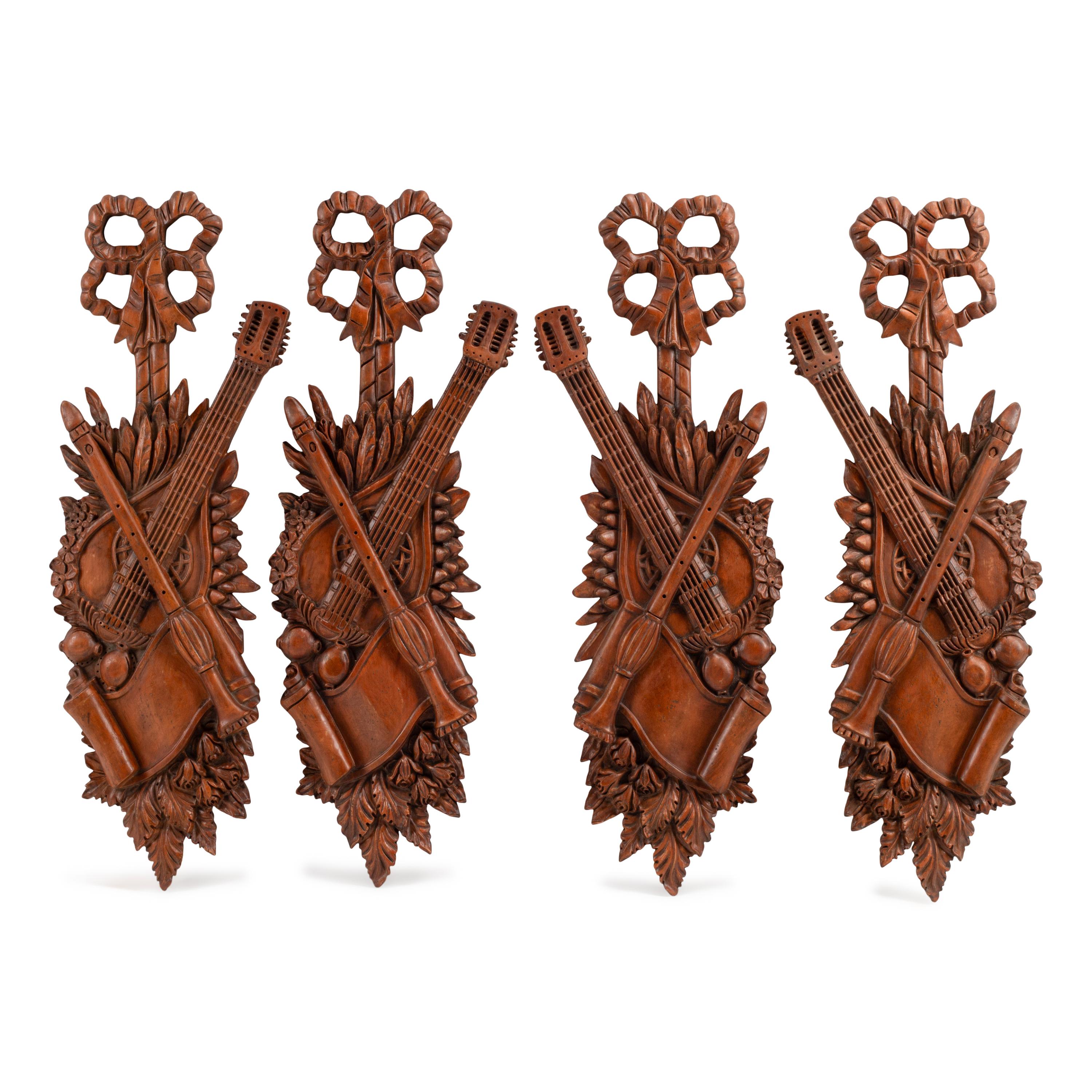 A Set of Four Italian Renaissance Style Carved Wood Wall Trophies