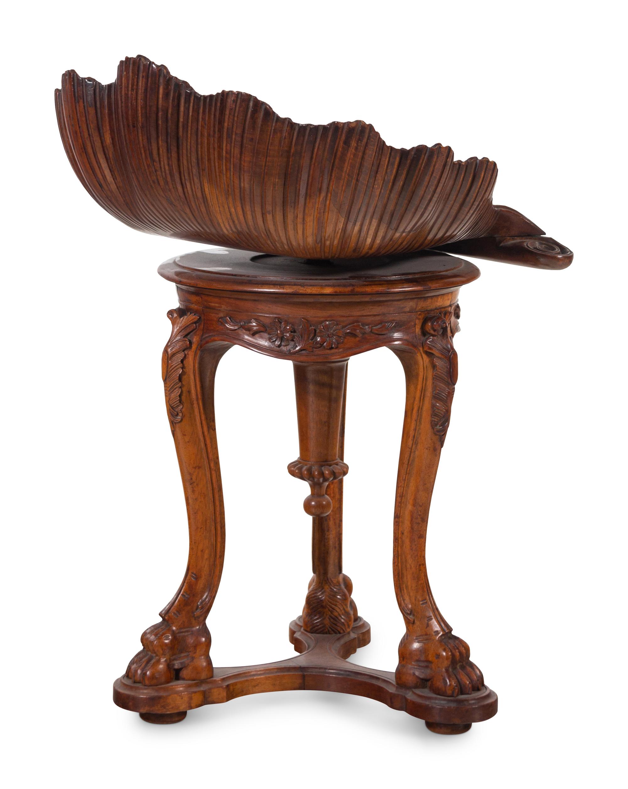 An Italian Carved Walnut Shell-Form Piano Stool