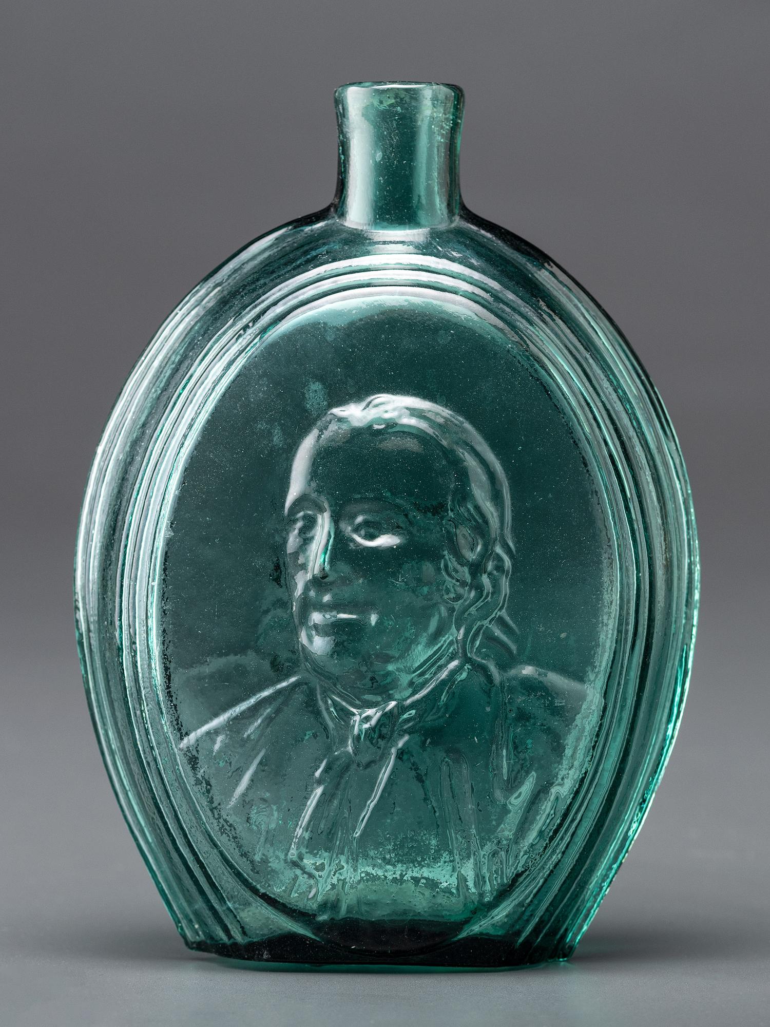 A Benjamin Franklin Portrait Flask in Green Glass by Kensington Glass Works, Philadelphia