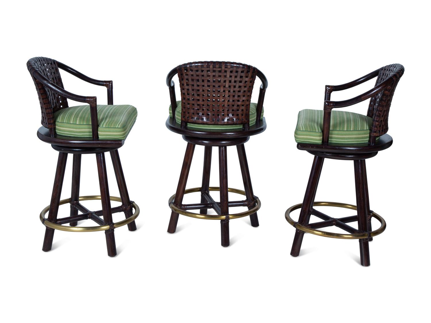 A Set of Three Stained Wood, Leather and Brass Bar Stools — 20TH CENTURY