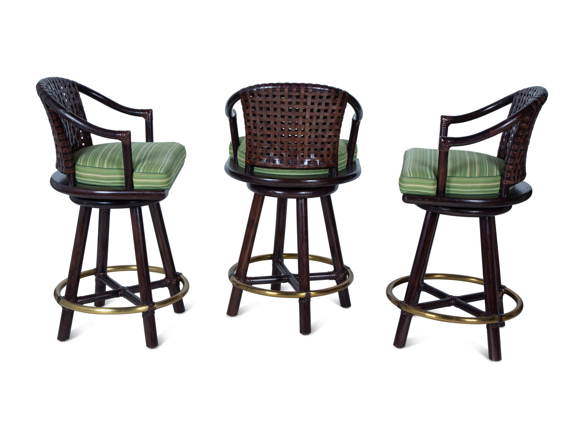 A Set of Three Stained Wood, Leather and Brass Bar Stools — 20TH CENTURY
