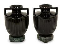 A Pair of Black Porcelain Urns on Green Marbelized Bases