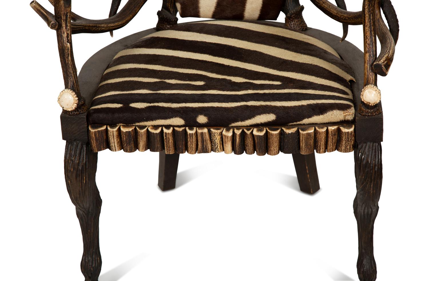 A Pair of Stag Antler Arm Chairs with Zebra Hide Upholstery Attributed to Anthony Redmile