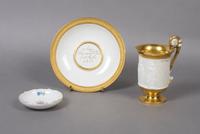 A Meissen Porcelain Cup and Saucer, Height of first 5 inches.