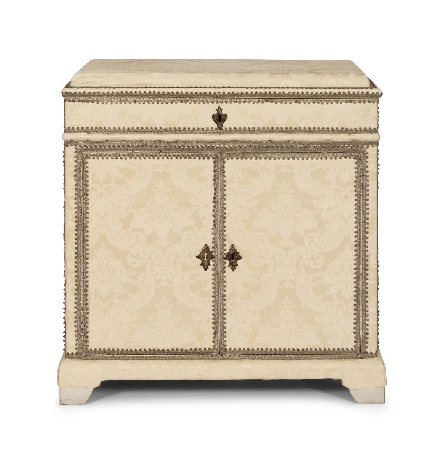 A Cream Damask-Upholstered And Painted Lift-Top Cabinet