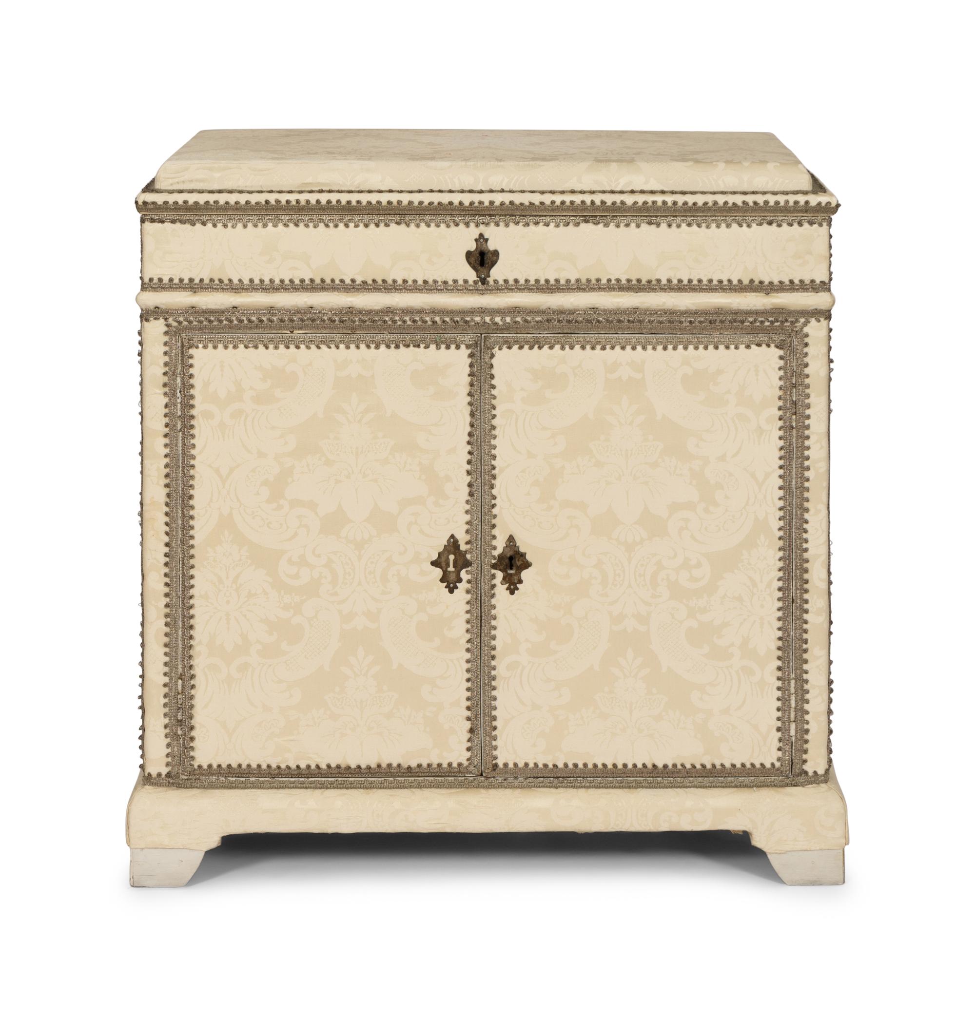 A Cream Damask-Upholstered And Painted Lift-Top Cabinet