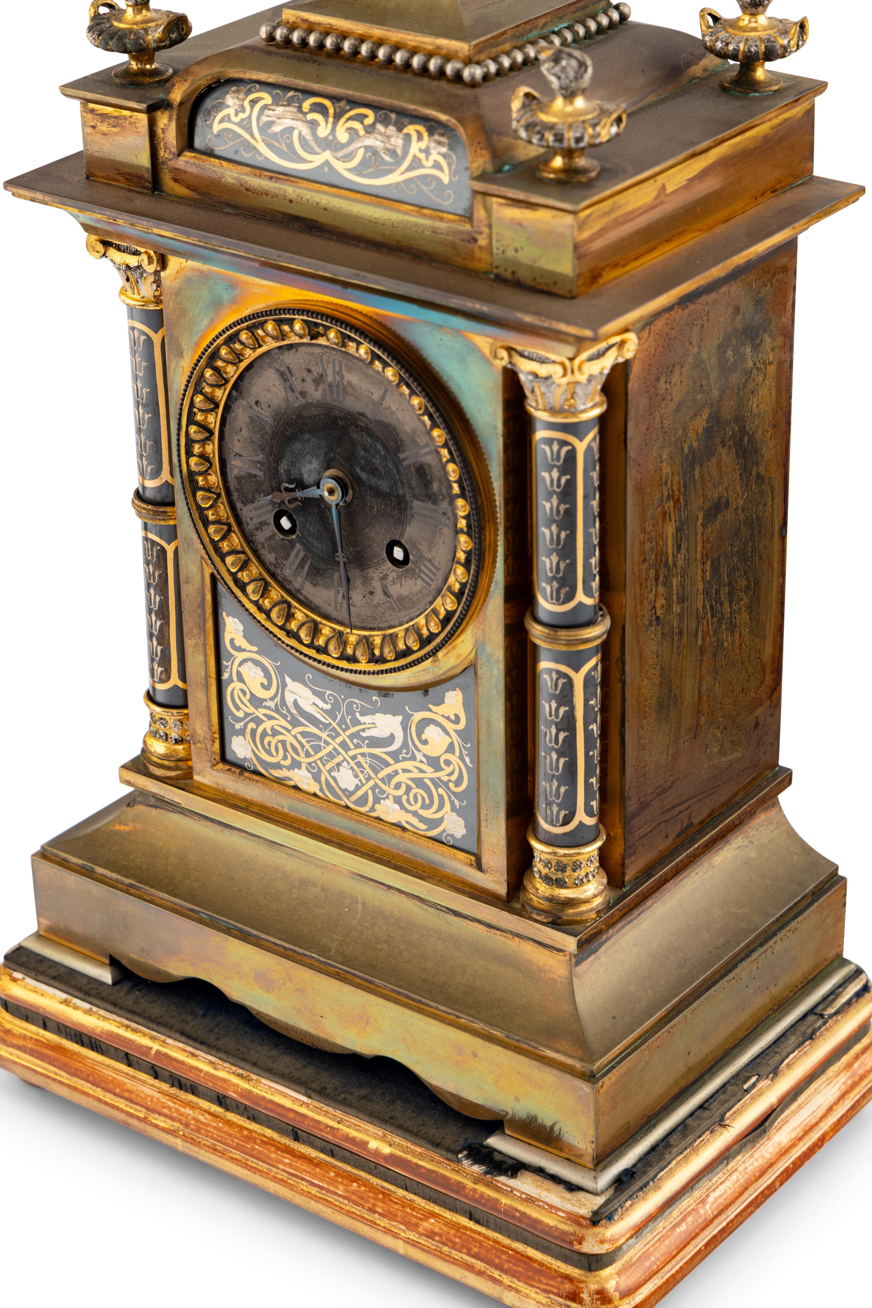 A French Brass and Mixed Metals Clock Garniture