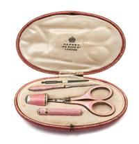 A Continental Five-Piece Guilloche Enamel Sewing Kit, Likely German, Retailed by Asprey, London, comprising scissors, a thimble, a stil