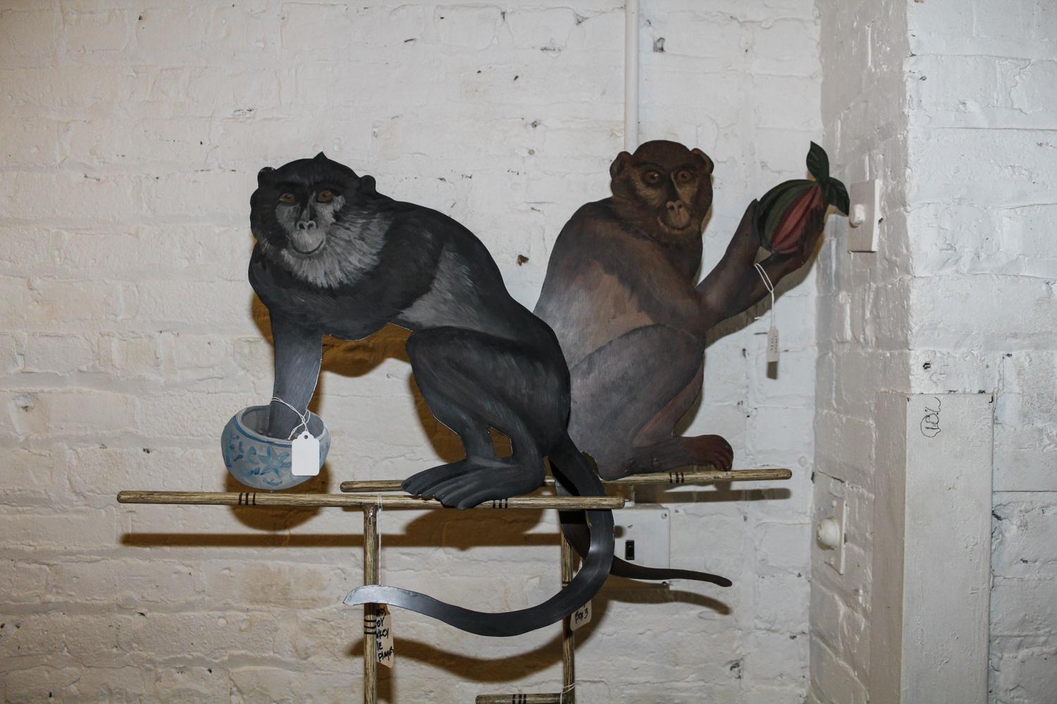 A Pair of Tole Monkey Plaques on Stands. Height 63 inches.