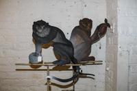 A Pair of Tole Monkey Plaques on Stands. Height 63 inches.