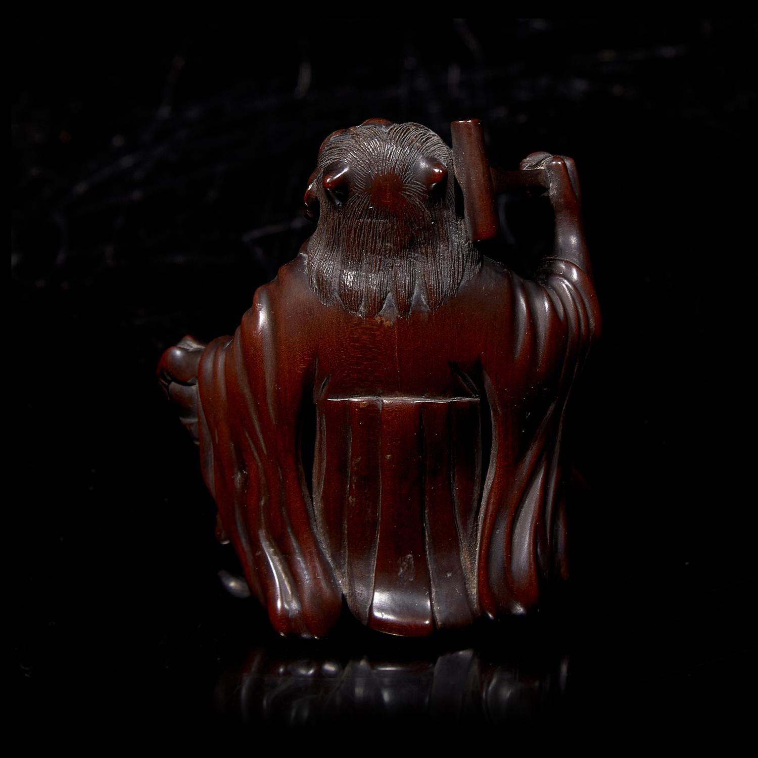A Japanese Carved Boxwood "Oni" Okimono, Meiji Period