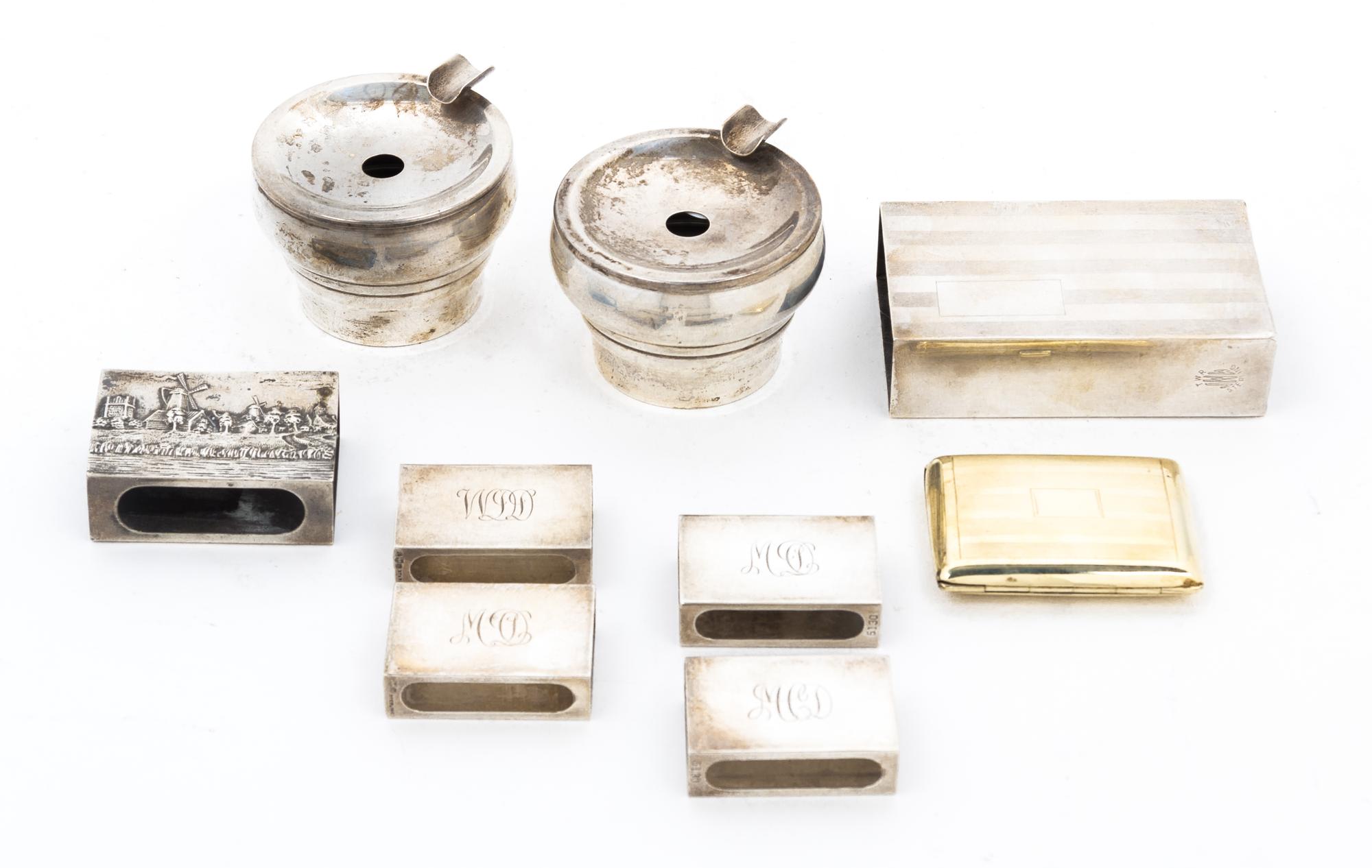 A Group of Eight Silver Smoking Articles, , consisting of five match box sleeves, two ash receivers, a match box, together with a silve