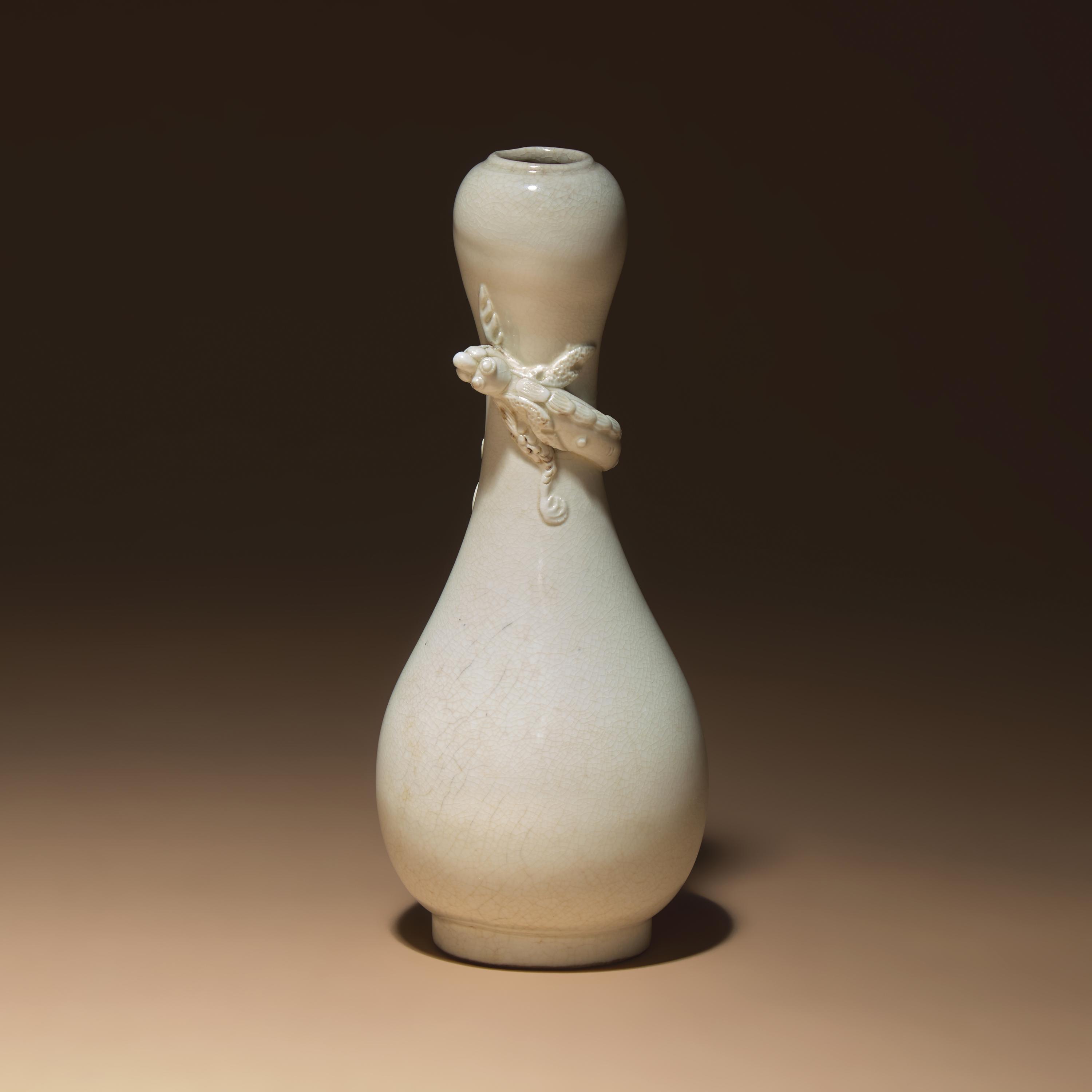 A Chinese White Glazed Porcelain 'Chilong' Bottle Vase, Qing Dynasty — 清 白釉盤螭龍瓶